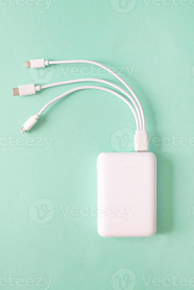 Powerbank on green background. Powerbank with different connectors. photo