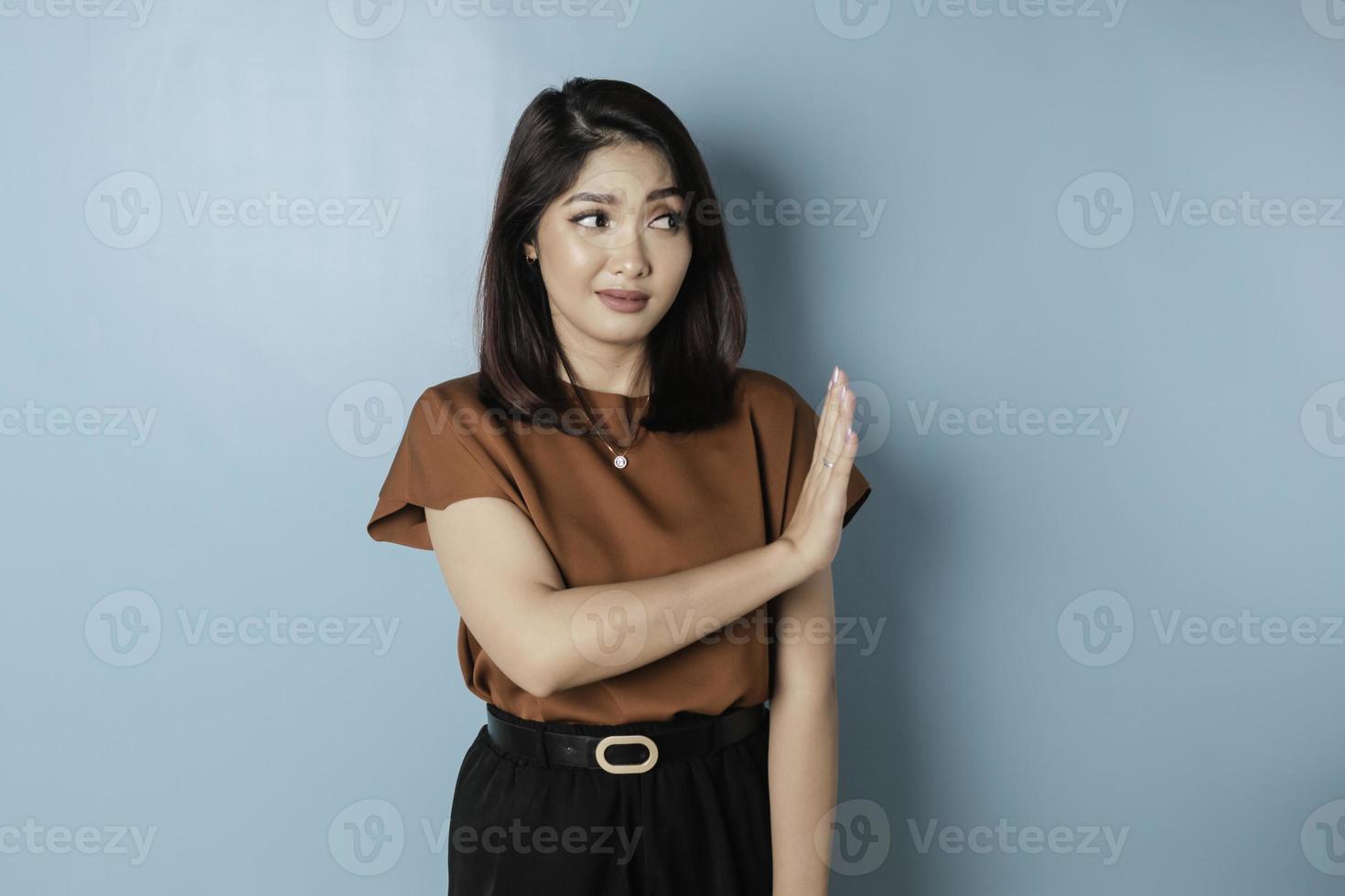 Beautiful Asian woman with hand gesture pose rejecting offer with copy space photo