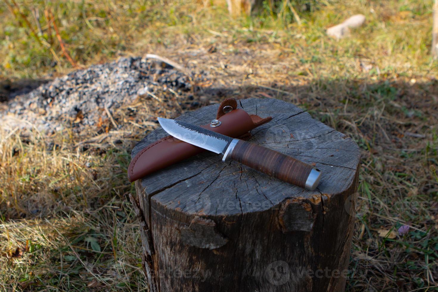 Hunting knife on a wooden surface photo