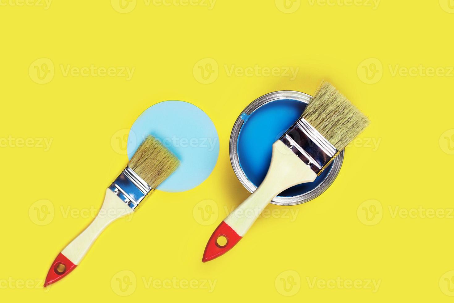 Colored background with paint jar and brushes. photo