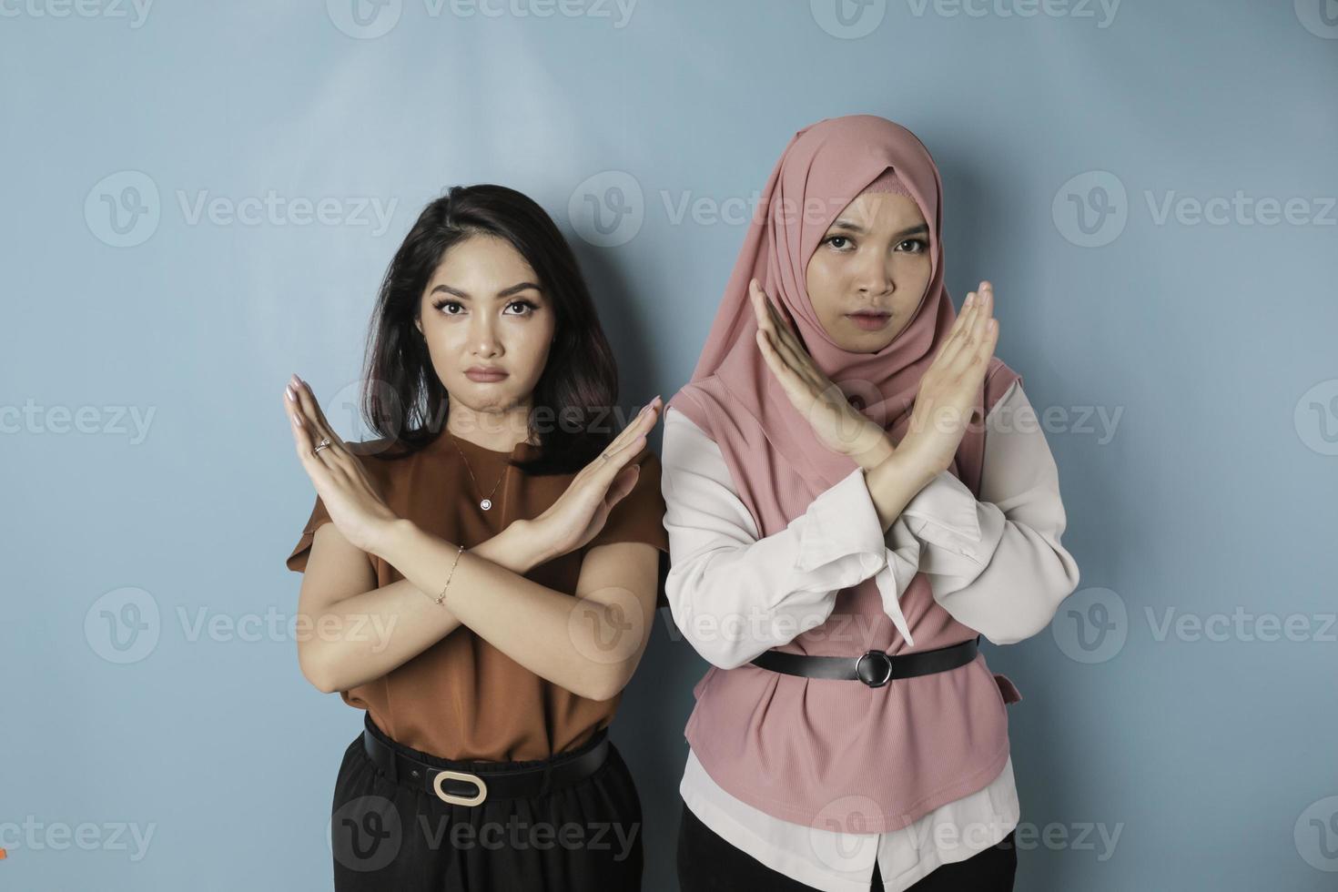 Beautiful Asian women with hand gesture pose rejection or prohibition with copy space photo