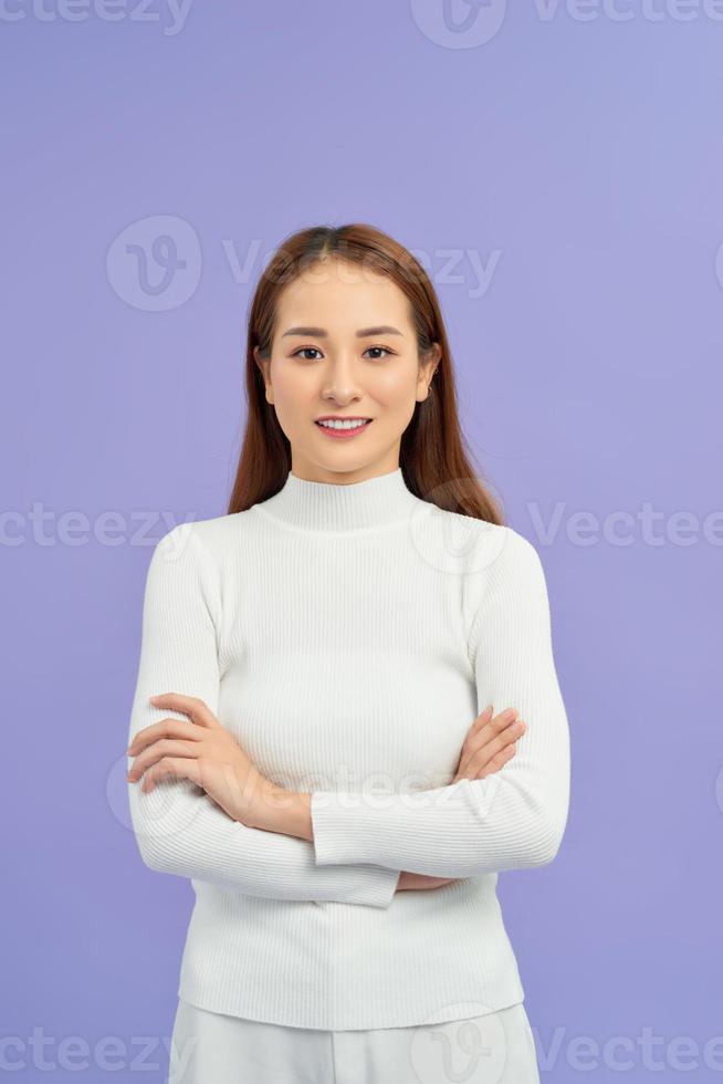 Laighing woman with crossed arms looking at the camera over white background photo
