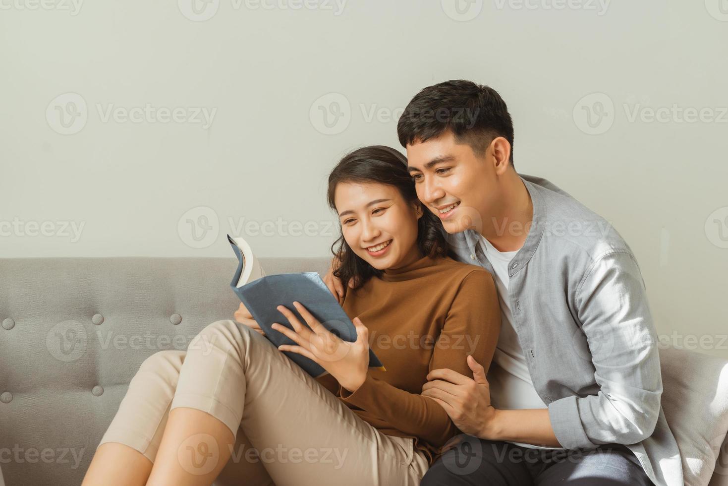 smiling romantic couple riding from the same book photo