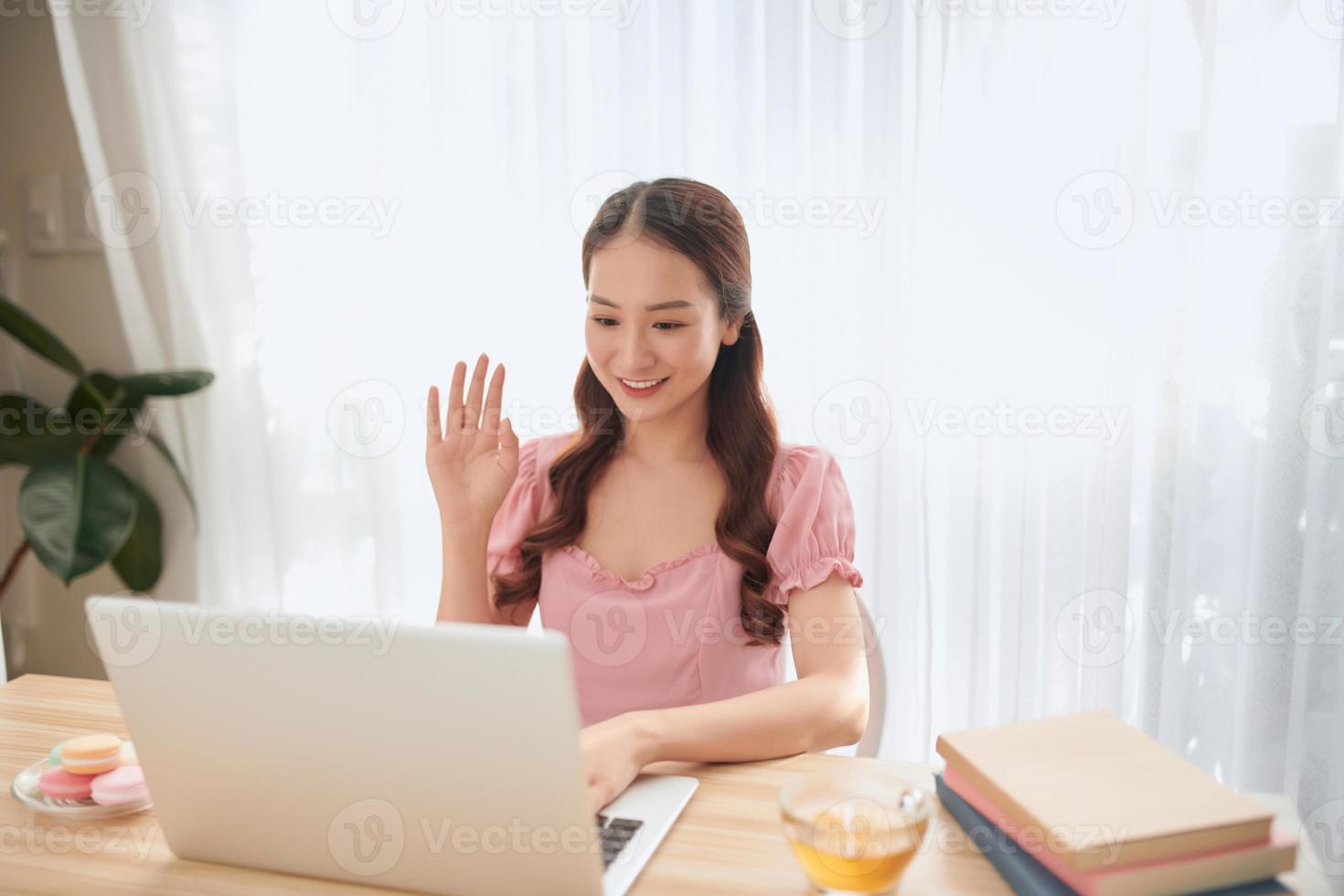 Young concentrated woman enjoying work on laptop. photo