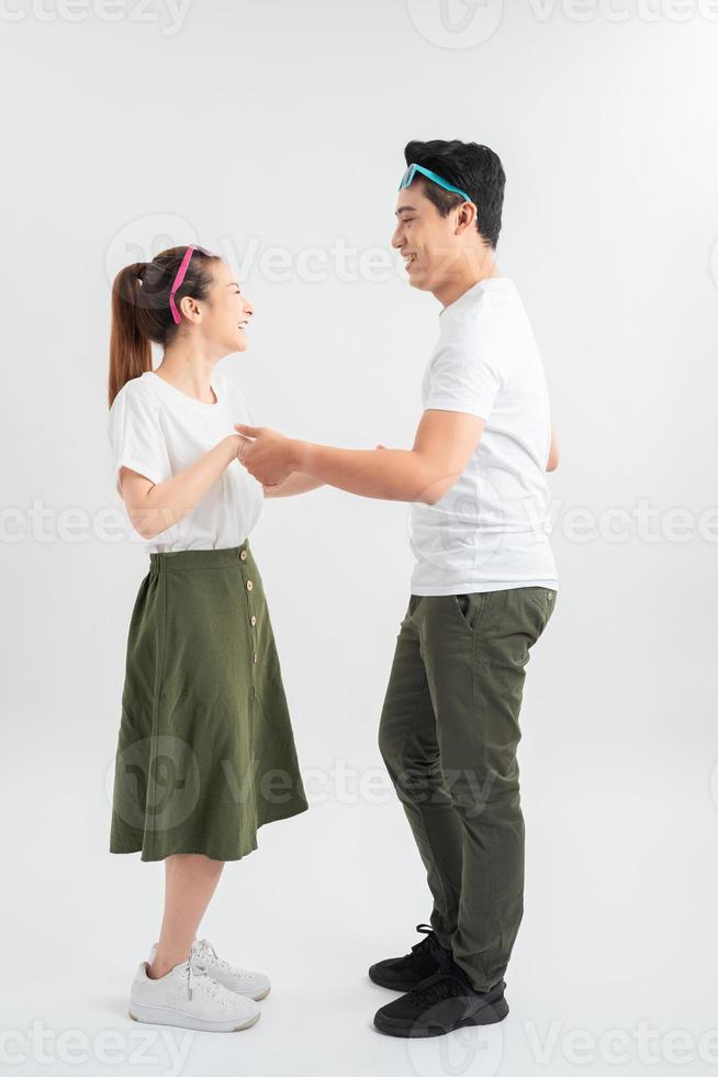 Full length shot of asian couple isolated on white. Man in casual attire chilling with girlfriend photo