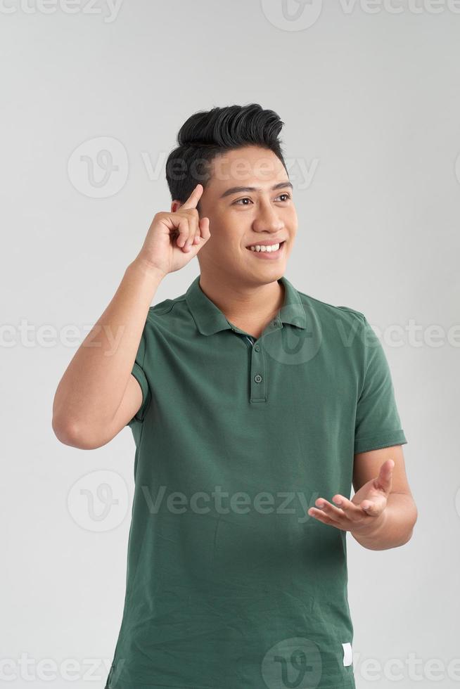 Portrait of a handsome young man thinking on something, isolated on white background photo