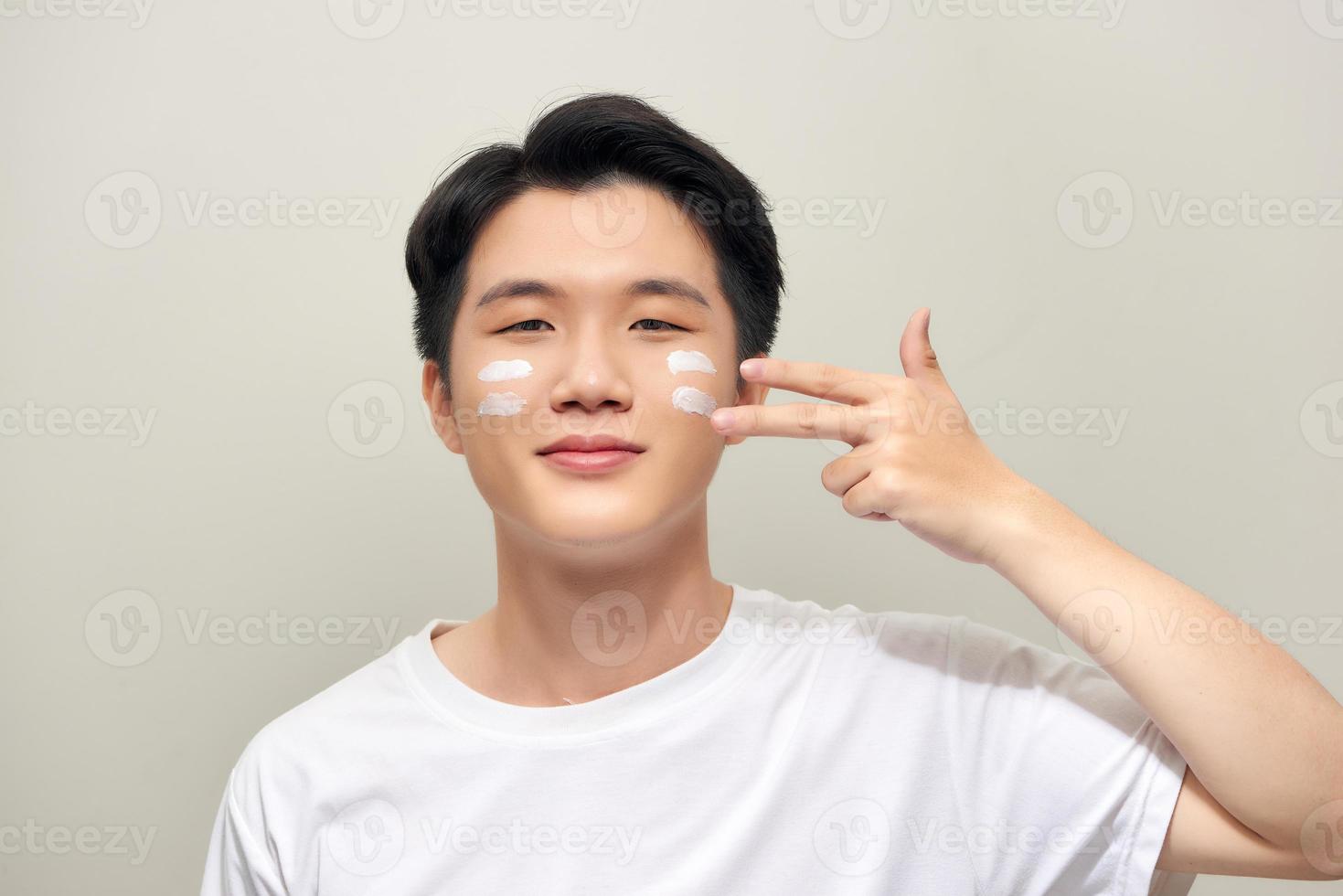 Handsome man applying - anti-aging concept photo