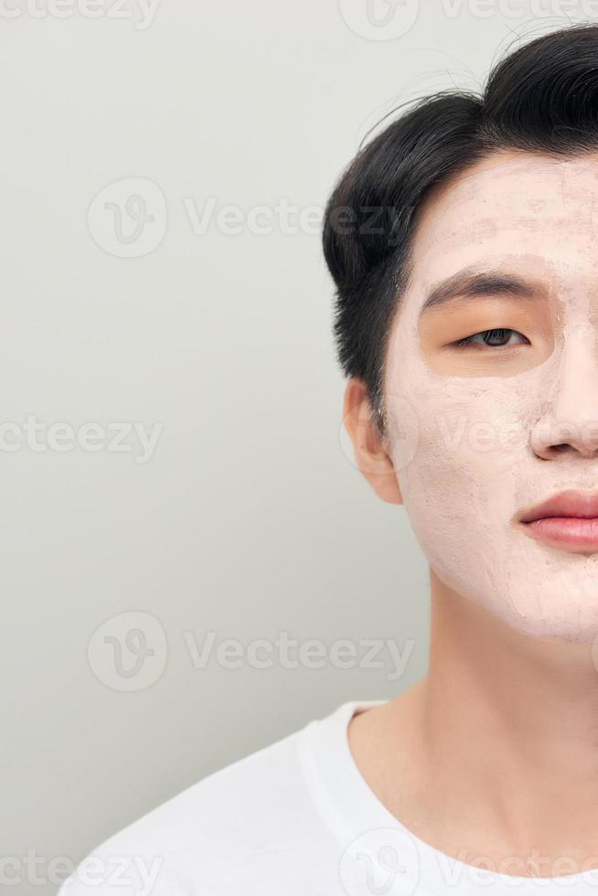 man with a mud mask on his face photo