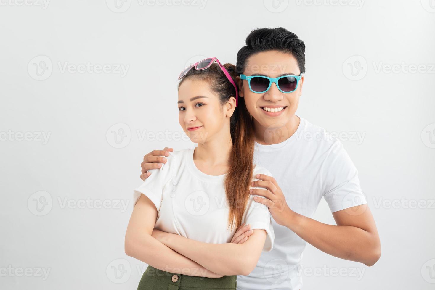 Surprised young couple looking at camera. Front view of excited young man and woman standing together and looking at camera on white background. Emotion concept photo