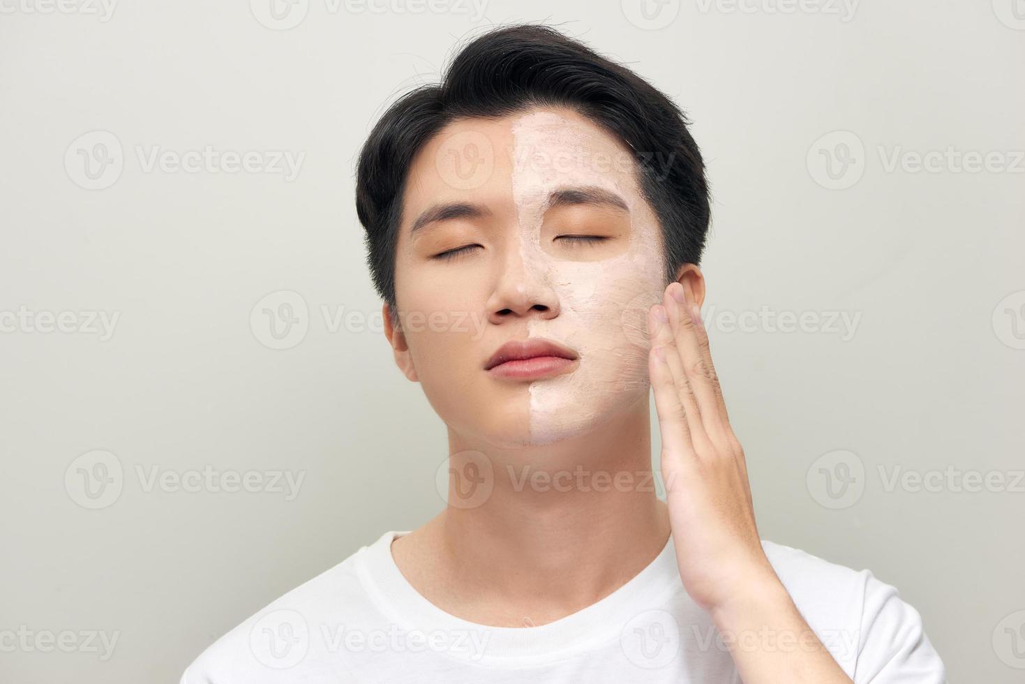 Photo of man with cosmetic clay mask on his face isolated over white background