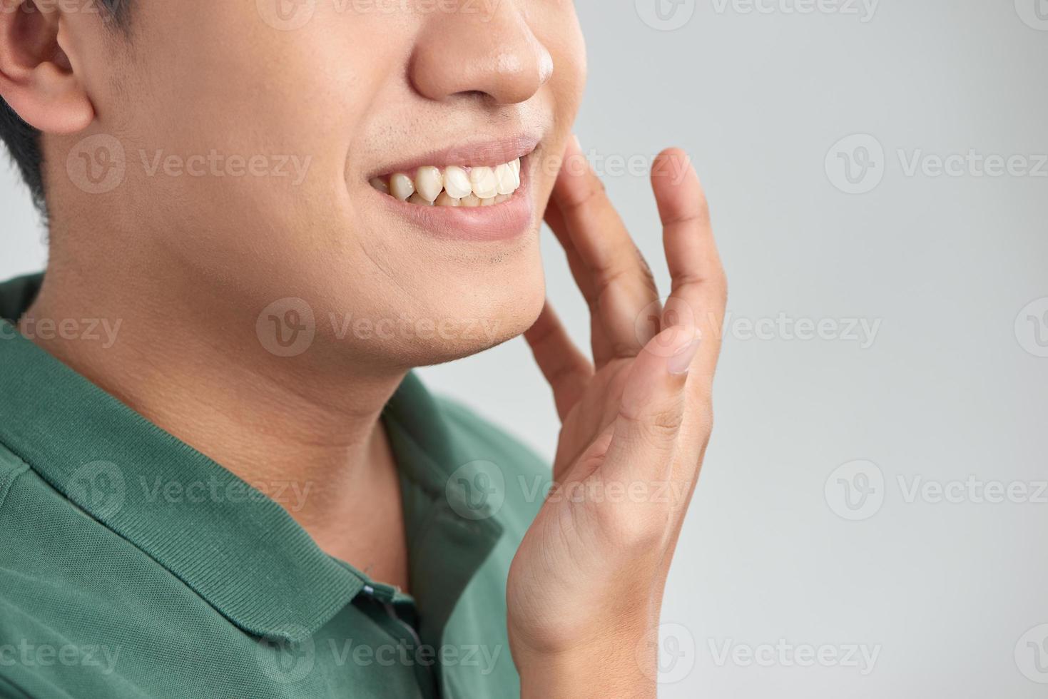 Close up portrait of satisfied confident handsome guy touching with shaved flawless clean soft skin after morning shaving, photo