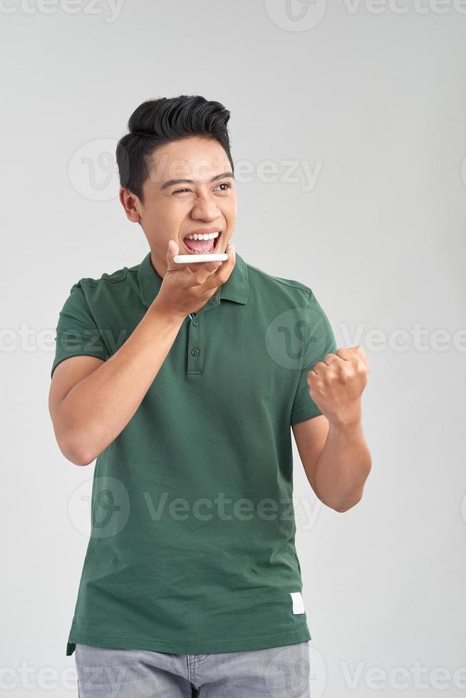 Happy man using voice recognition on mobile phone to send a recorded message photo