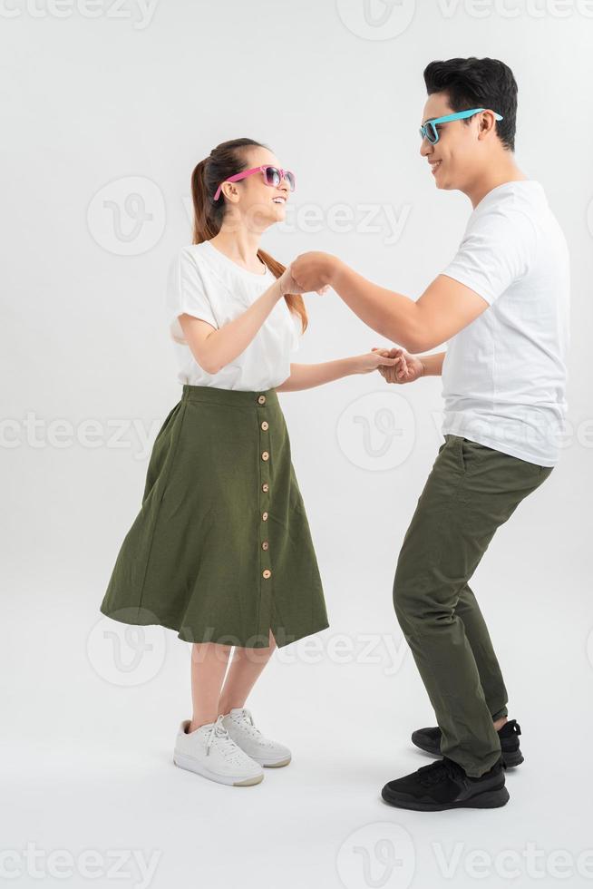 Attractive couple dancing isolated over white background photo