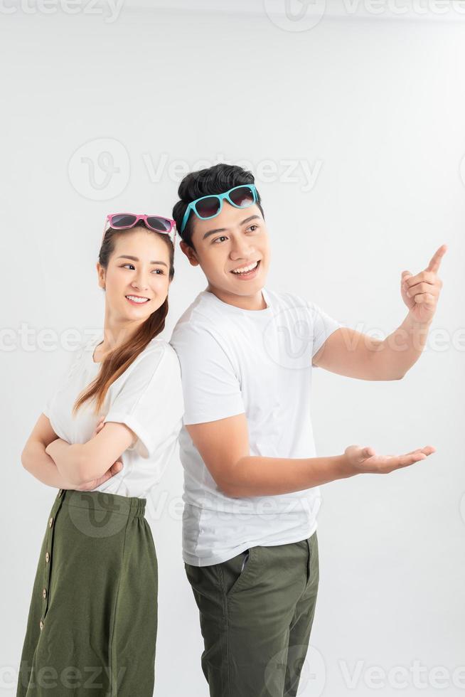 Joyful couple standing back-to-back and laughing at joke. photo