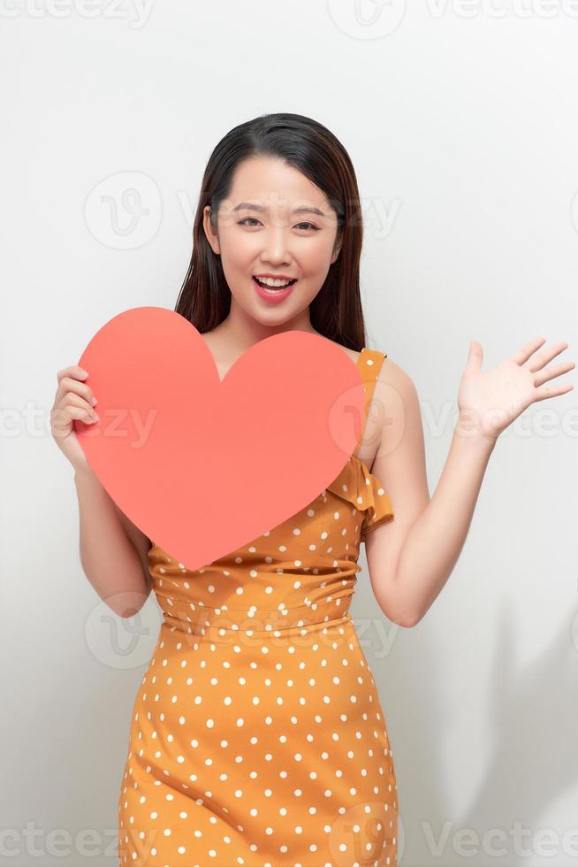 Young woman with red heart isolated on white background photo