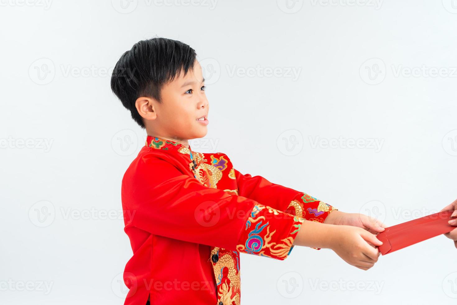 Vietnamese boy in a red ao dai received an envelope. Lunar new year concept. photo