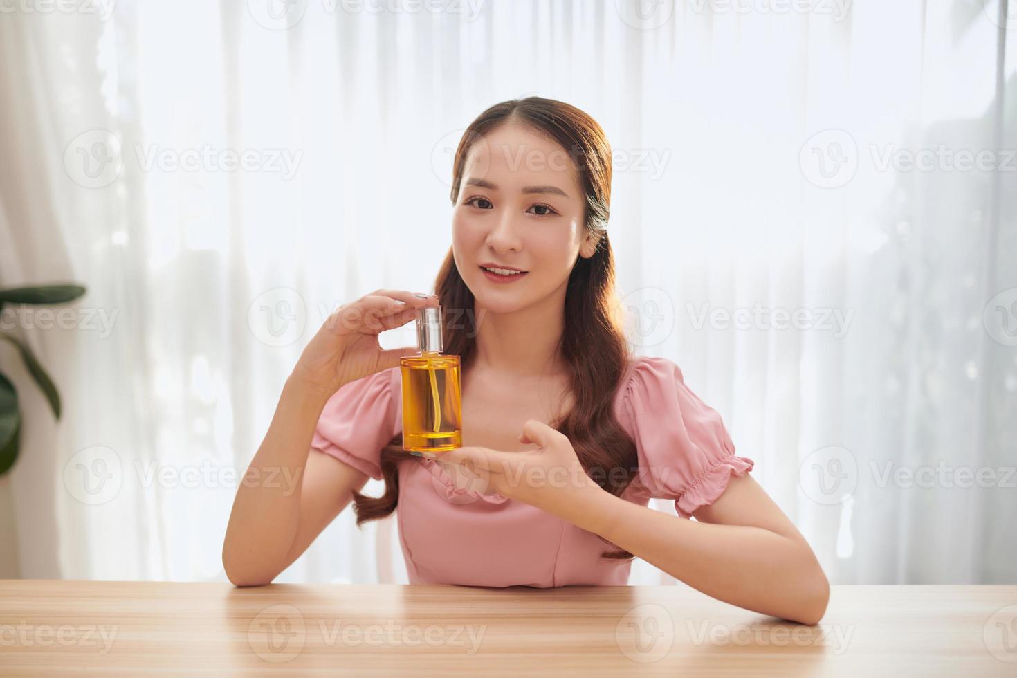 Young Asian woman introducing her product on her vlog. Blogger concept photo