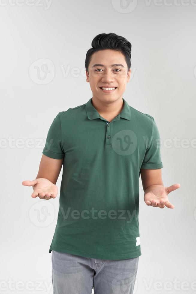 Beautiful casual man with green t-shirt talking with two hand open happy on white background photo