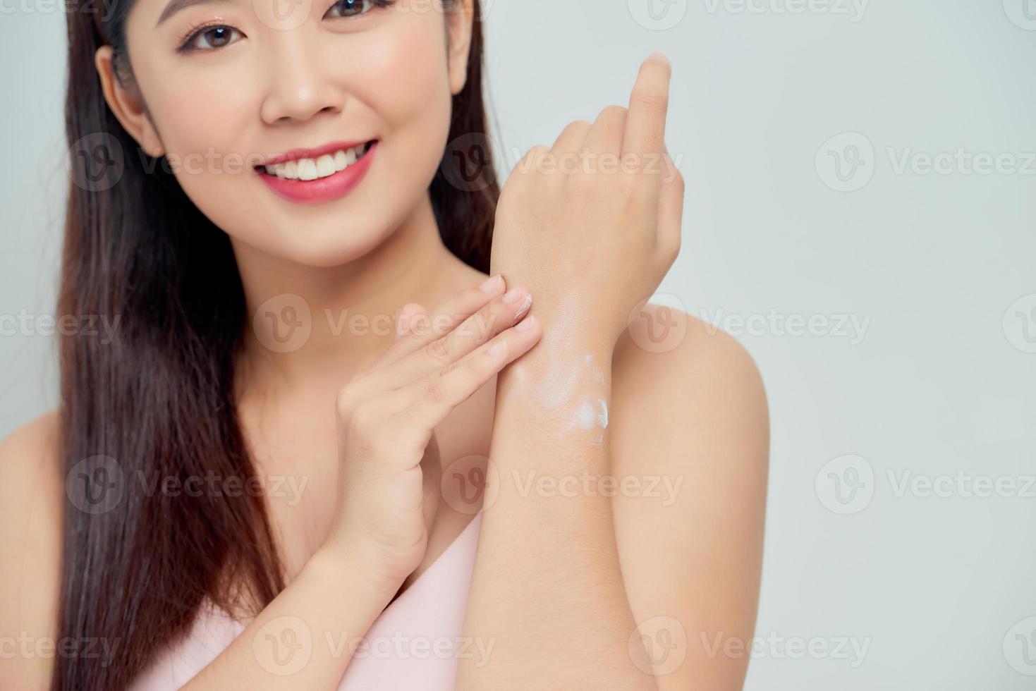 closeup of female hands applying hand cream photo
