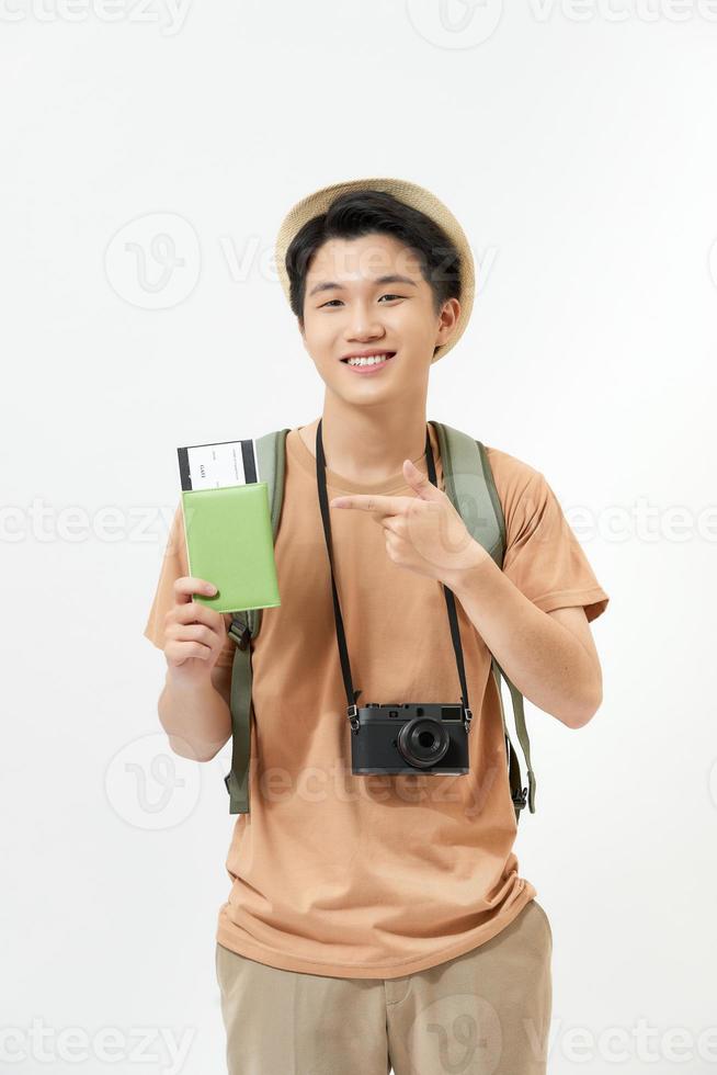 Young male traveler is excited about a new trip while holding his passport and some tickets. photo