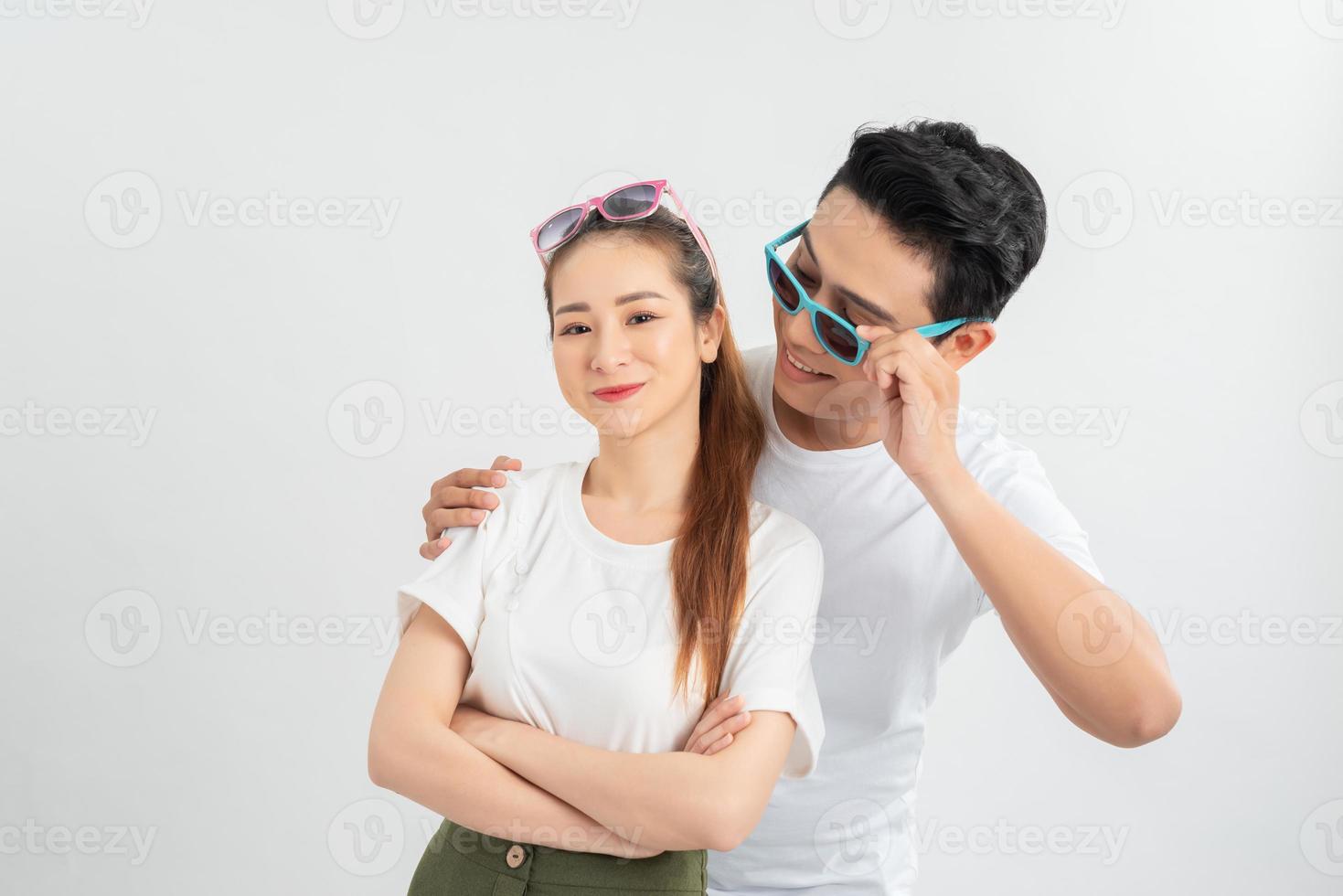 Studio shot of two surprised terrific woman and man look in bewilderment, touch rim of spectacles, being amazed by sudden news, stand against white background photo