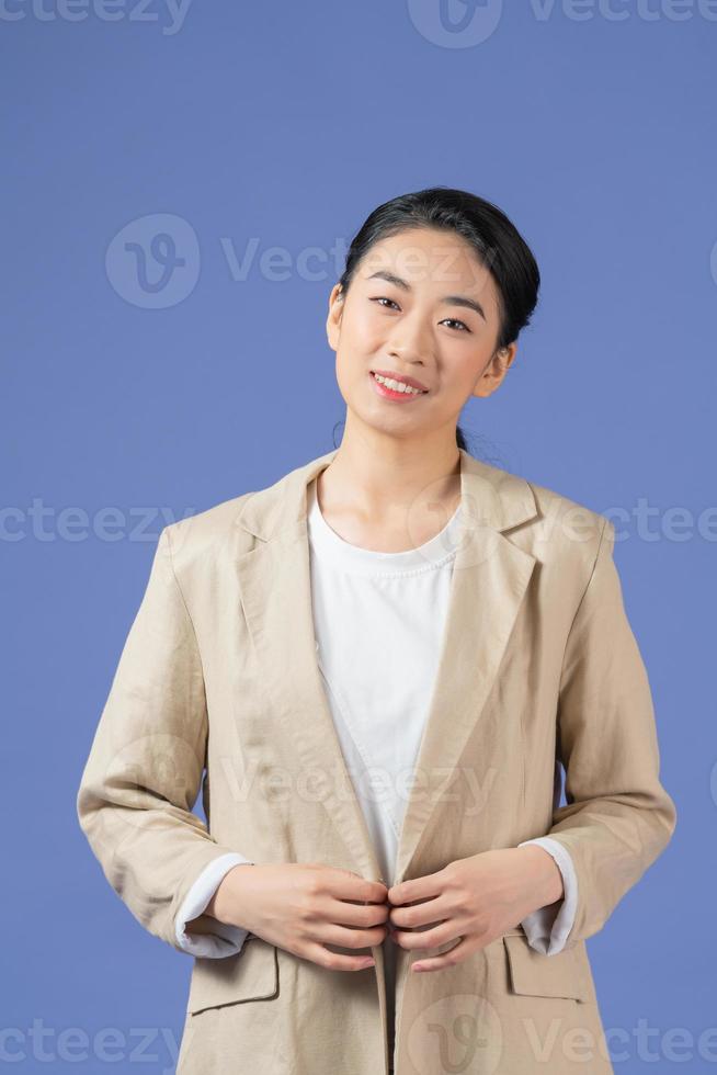 Young woman news commentator with crossed arms looking away isolated on purple photo