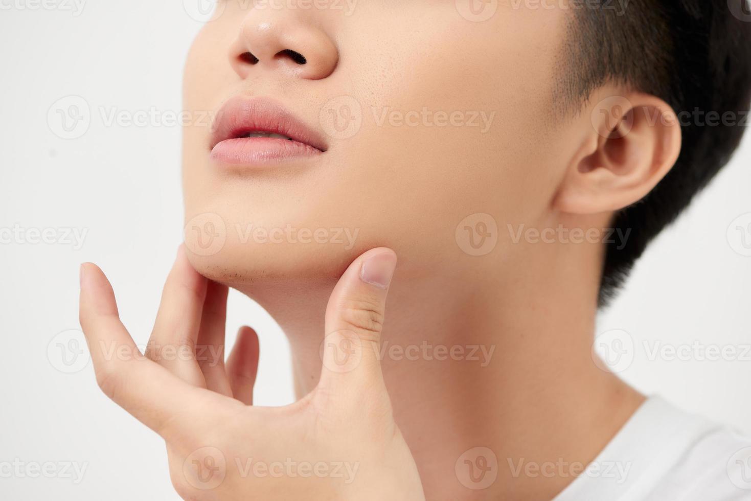 Cropped portrait of a smiling man with hand on chin isolated over white background photo
