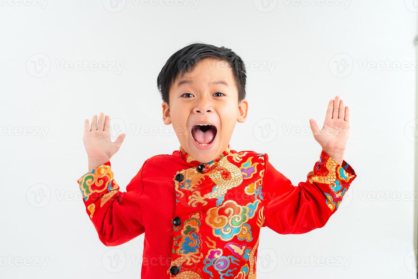 Cute Asian child is surprise and so happy about it in ao dai on white background isolated photo