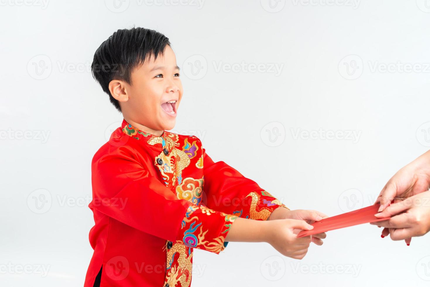 Vietnamese boy in a red ao dai received an envelope. Lunar new year concept. photo