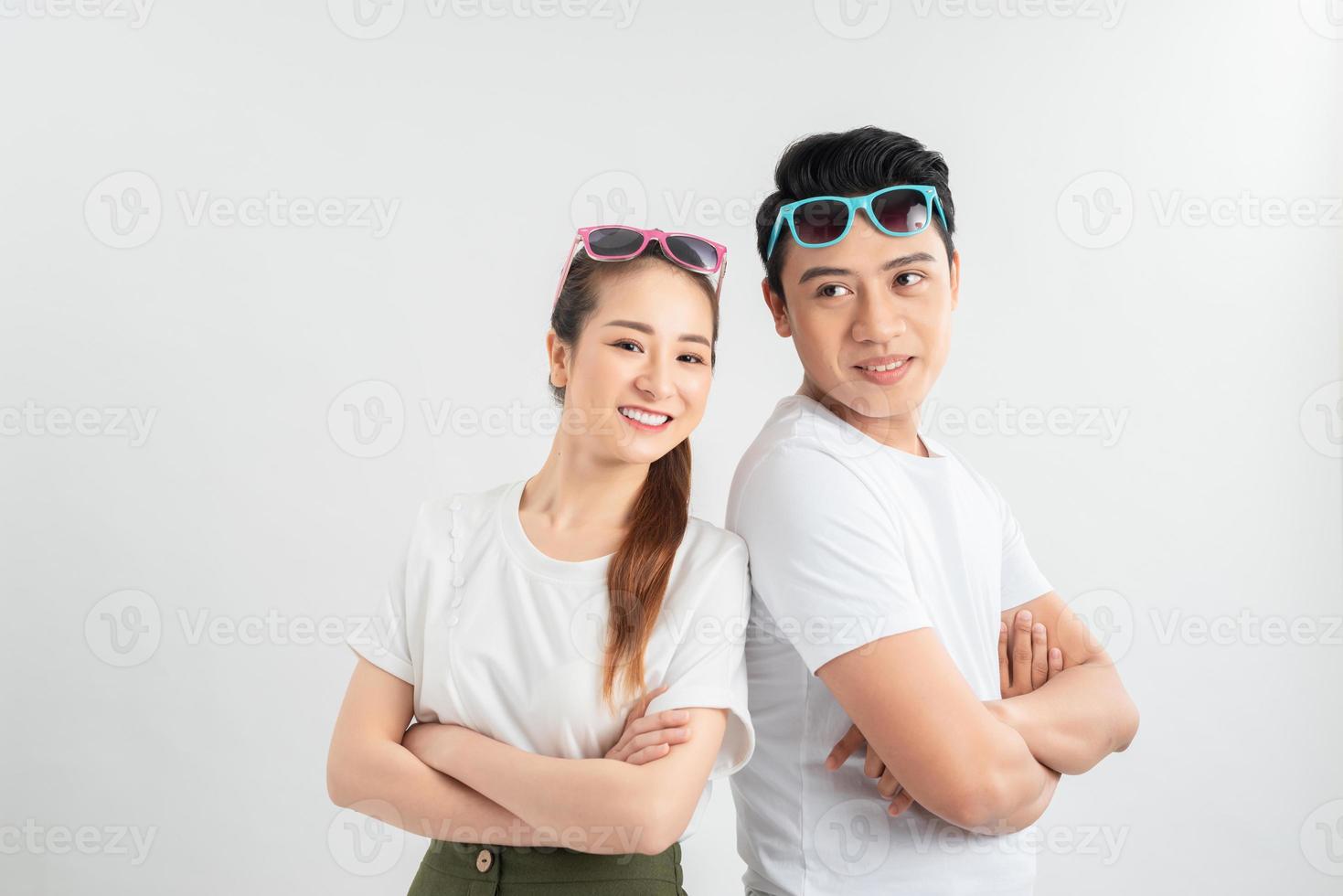emotions and people concept - portrait of happy couple in white t-shirts celebrating success over white background photo