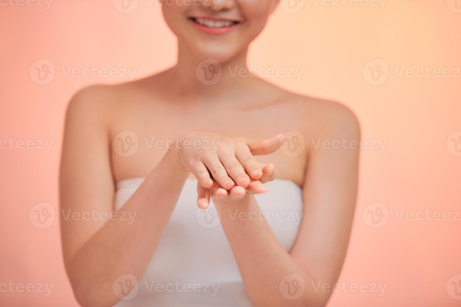 Cropped close up photo of young woman hands applying moisturizer cream body oil for smooth effect in spa