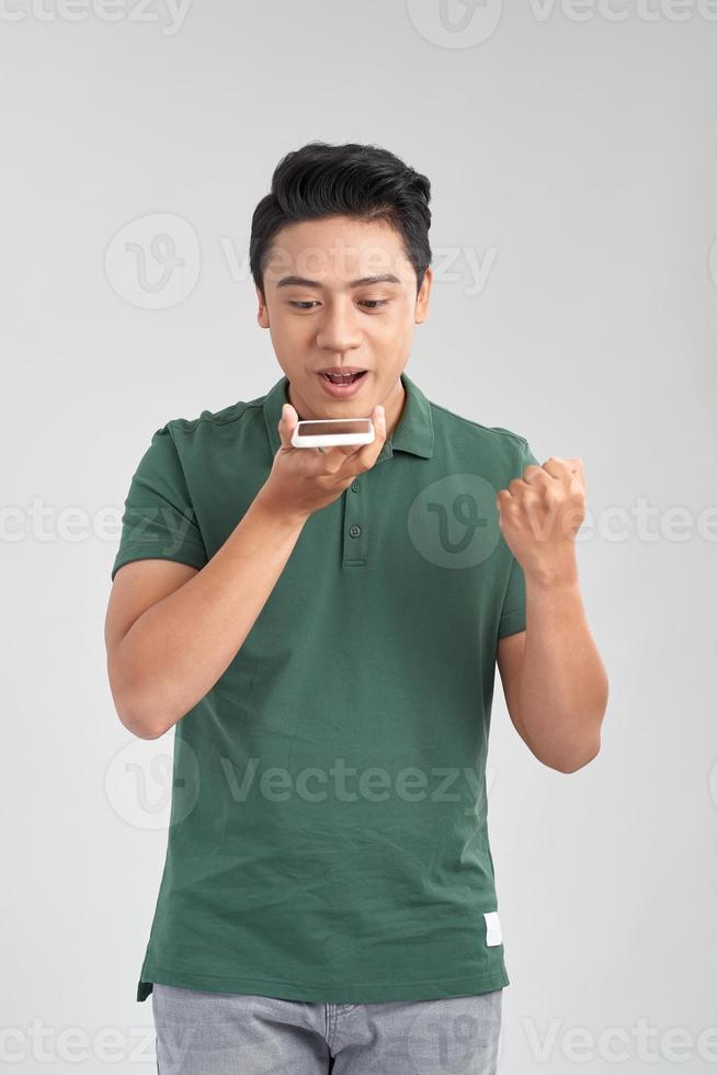 Happy man using voice recognition on mobile phone to send a recorded message photo