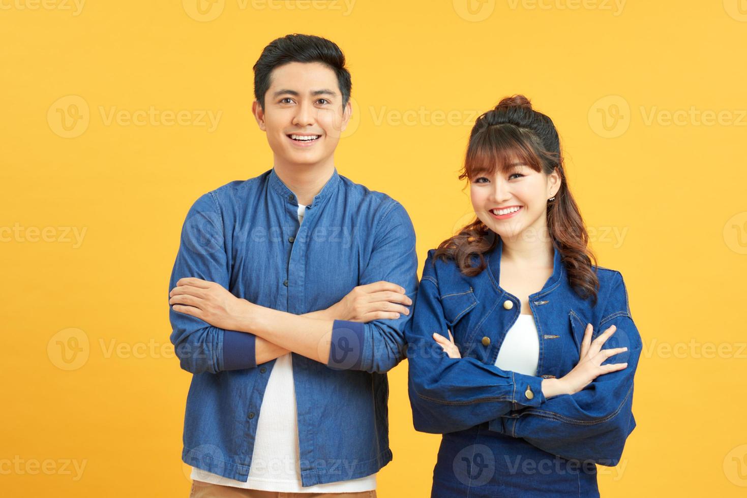 Happy loving couple. Studio shot of beautiful young couple in jeans wear standing and smiling photo