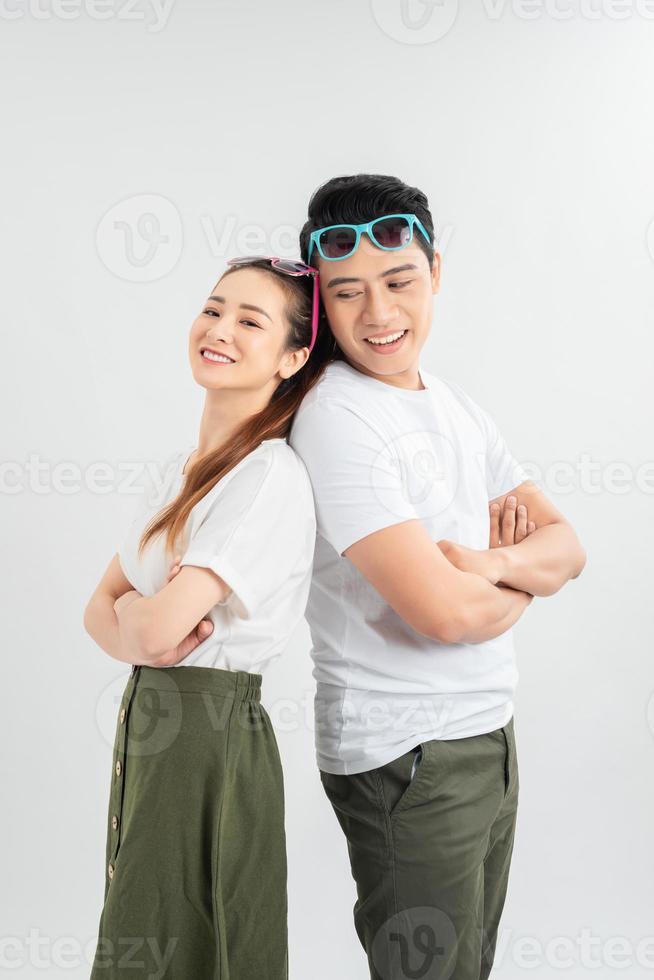 Cheerful hsppy man and woman with crossed hands standing back to back. photo
