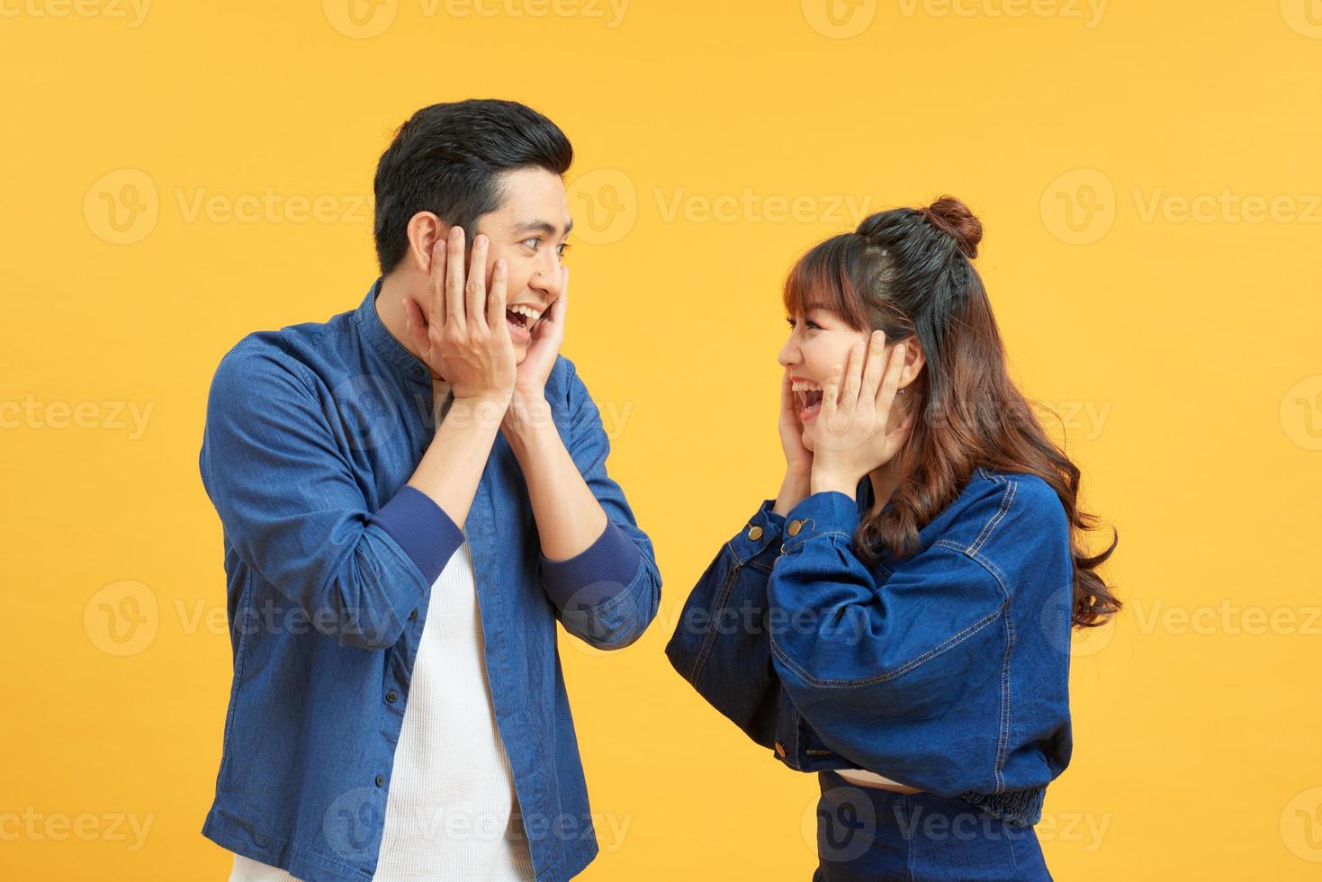 Studio shot of cheerful young people, clasp hands near face, rejoice positive moments in life, look joyfully at camera,  Emotions concept photo