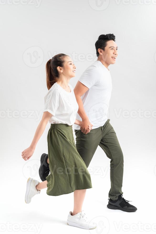 smiling boyfriend and attractive girlfriend in casual clothes holding hands photo