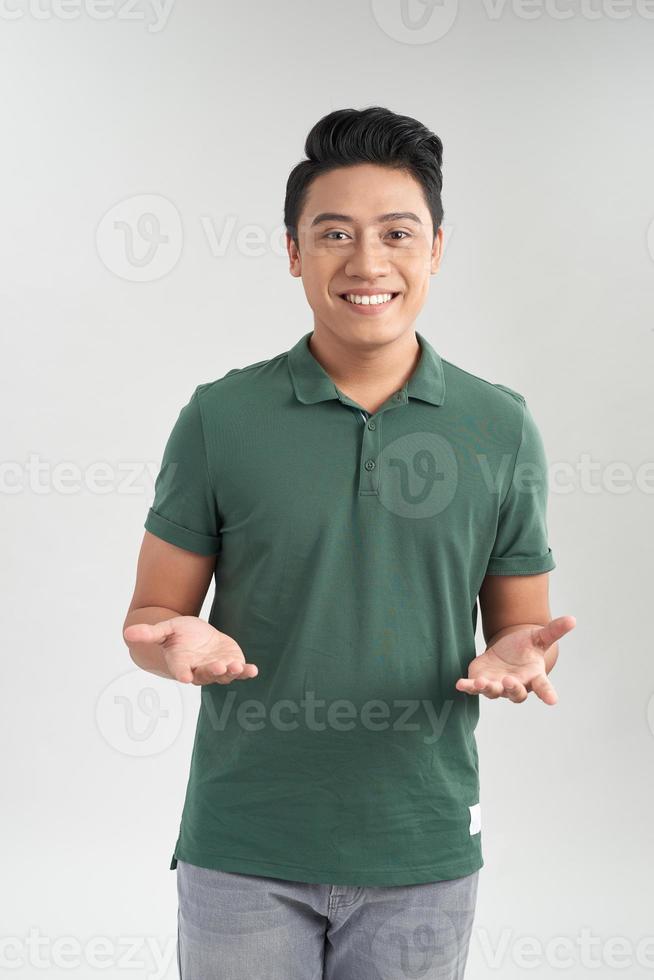 Smiling casual man welcoming you on white background photo