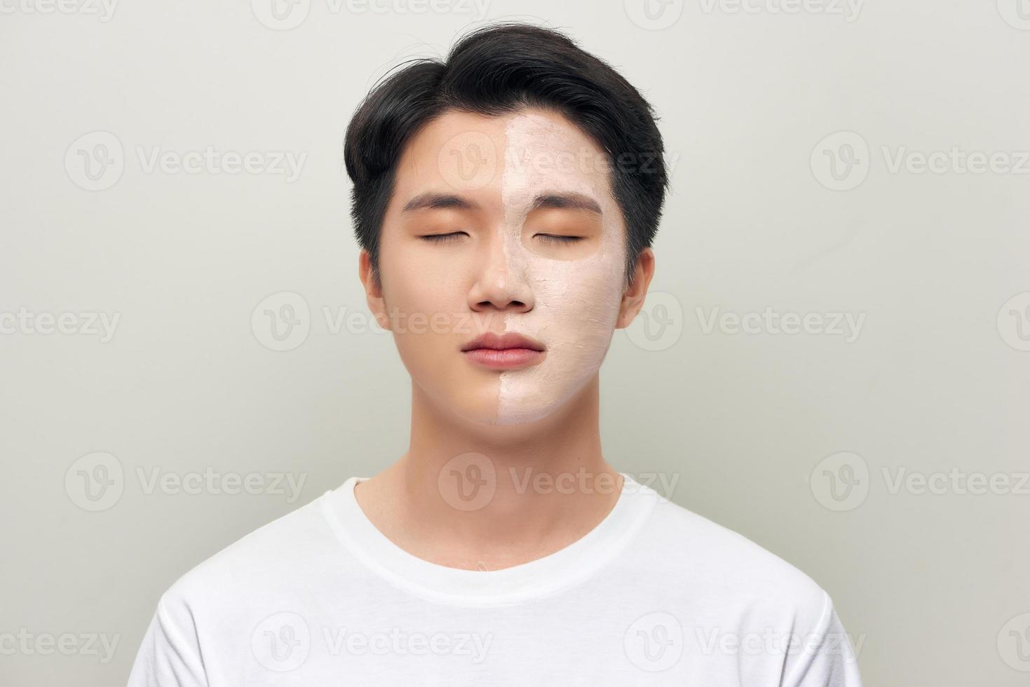 Front portrait of a white male wearing a mud mask beauty treatment. photo