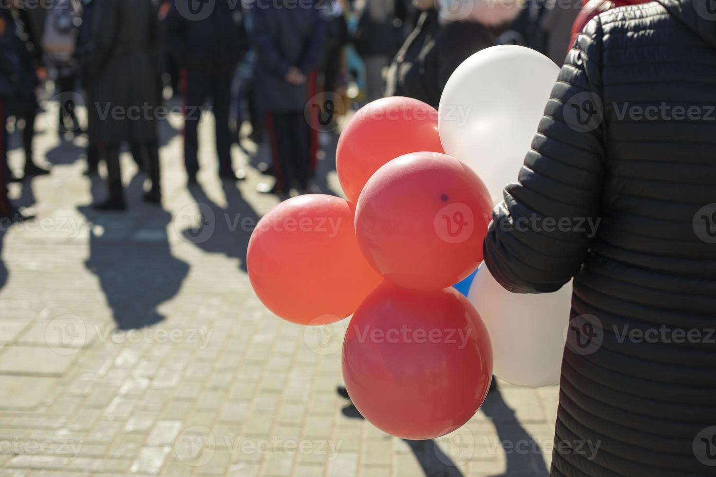 Balloons in hand. Balls at festival. photo