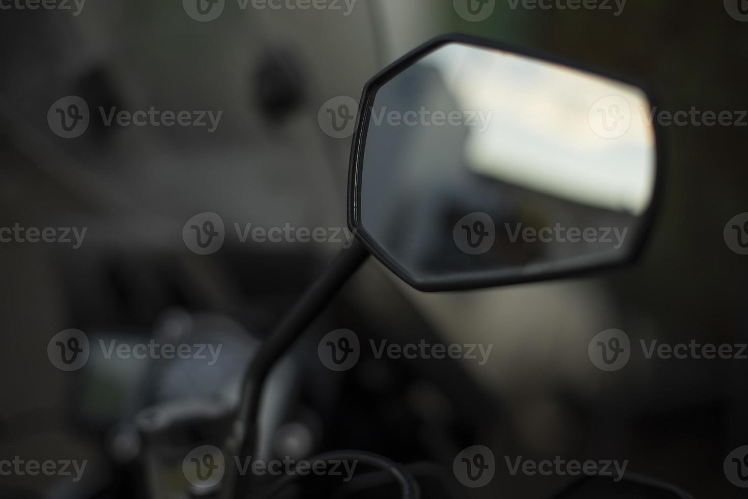 Rear-view mirror of motorcycle. Transport details. Road view tool. photo