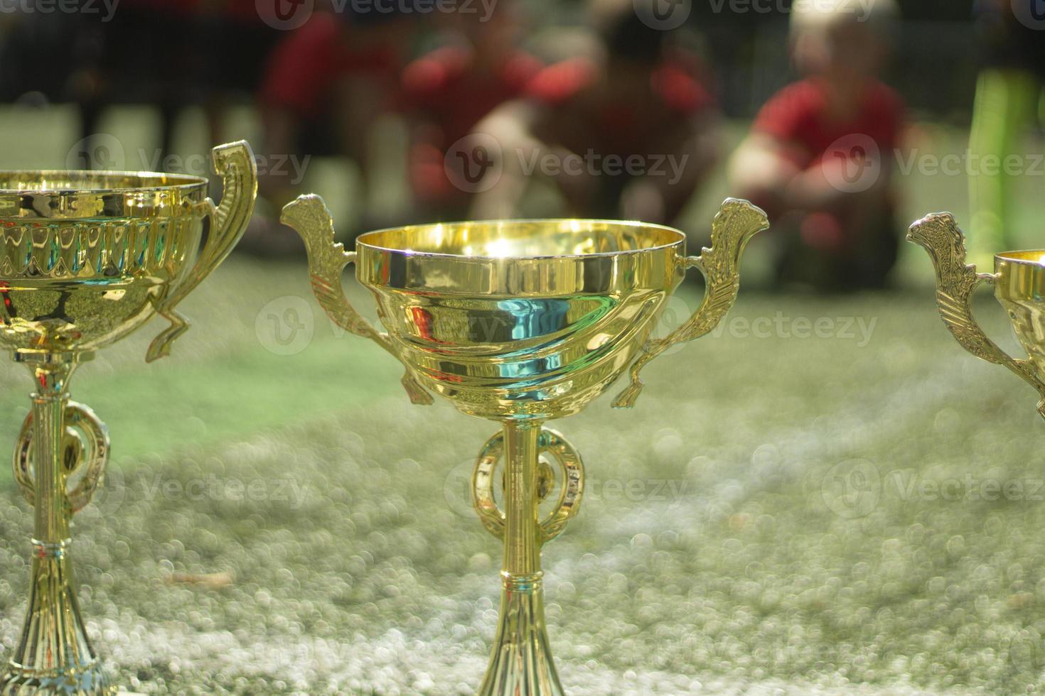 Gold Cups. Sports awards at competition. Details of football match. Products made of gold-plated steel. photo