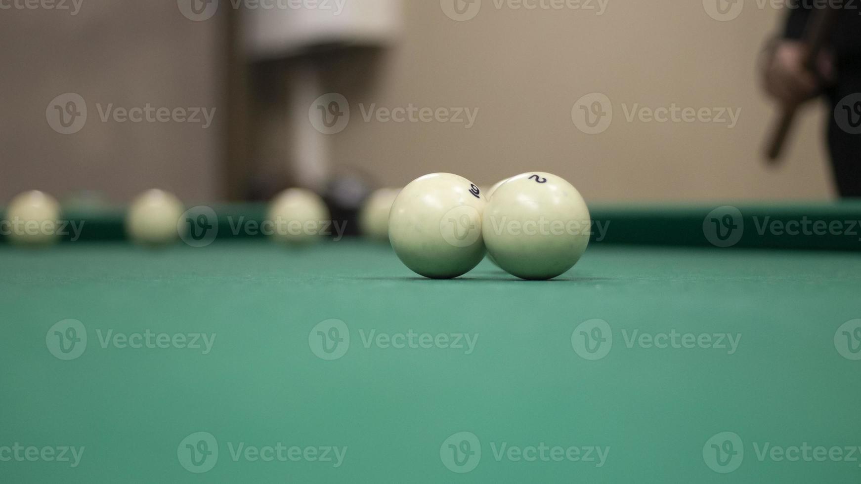 Billiard balls are white. Green billiard table. Playing in bar. Sports competition. photo