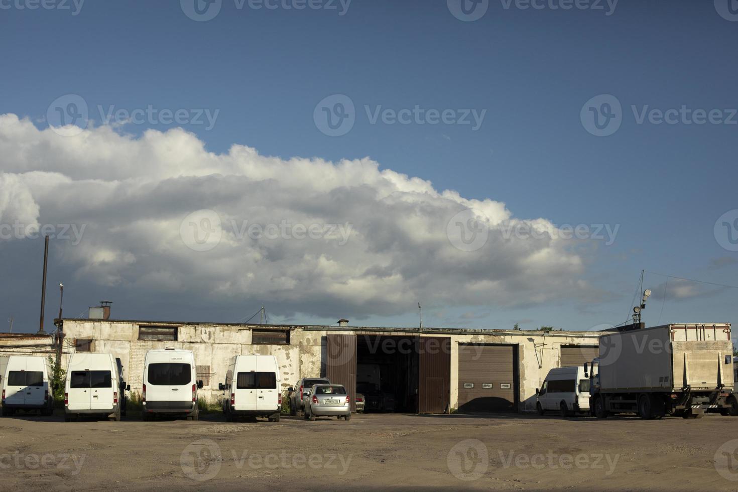 Garage for transport. Bus parking. Industrial zone with private cars. photo