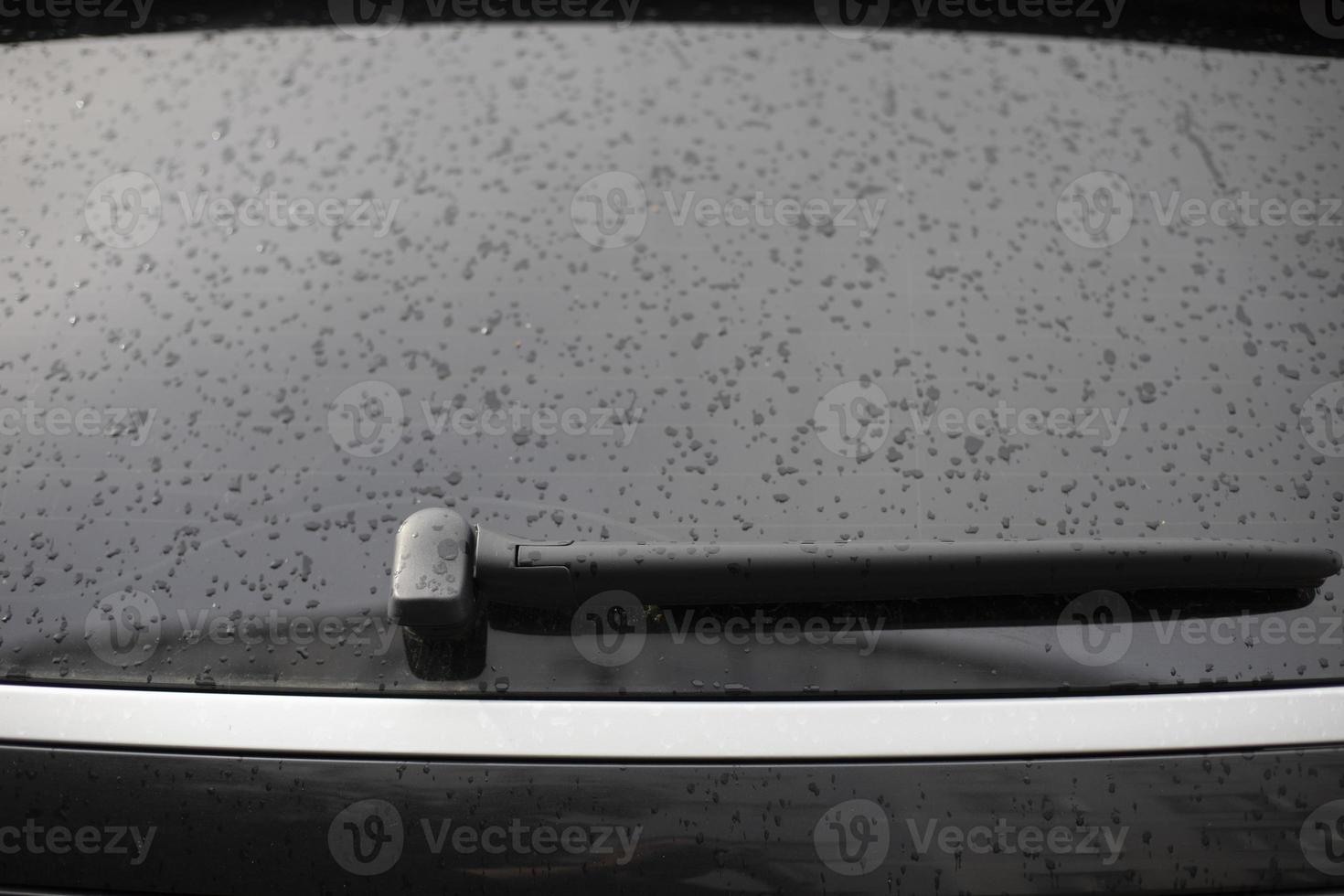 Wet car window. Rear window of transport. Drops on car. photo