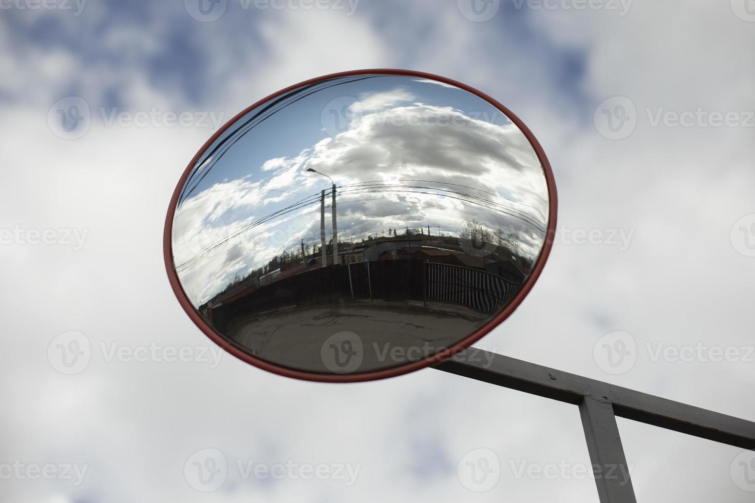 Round mirror. Reflector in parking lot. Mirror for safety. photo