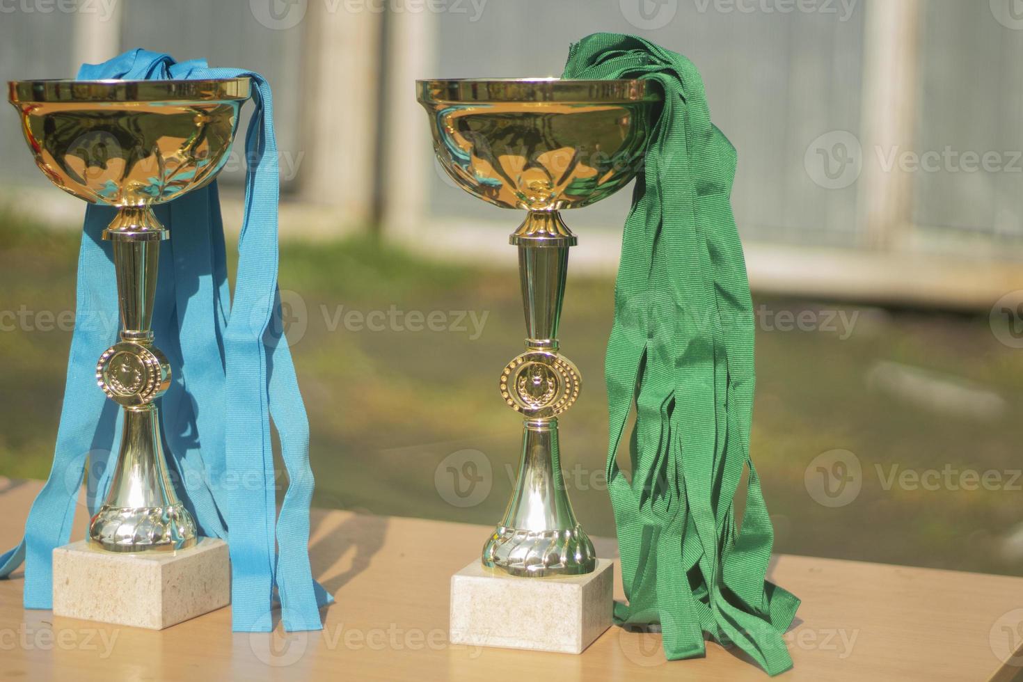 Gold Cups. Sports awards at competition. Details of football match. Products made of gold-plated steel. photo