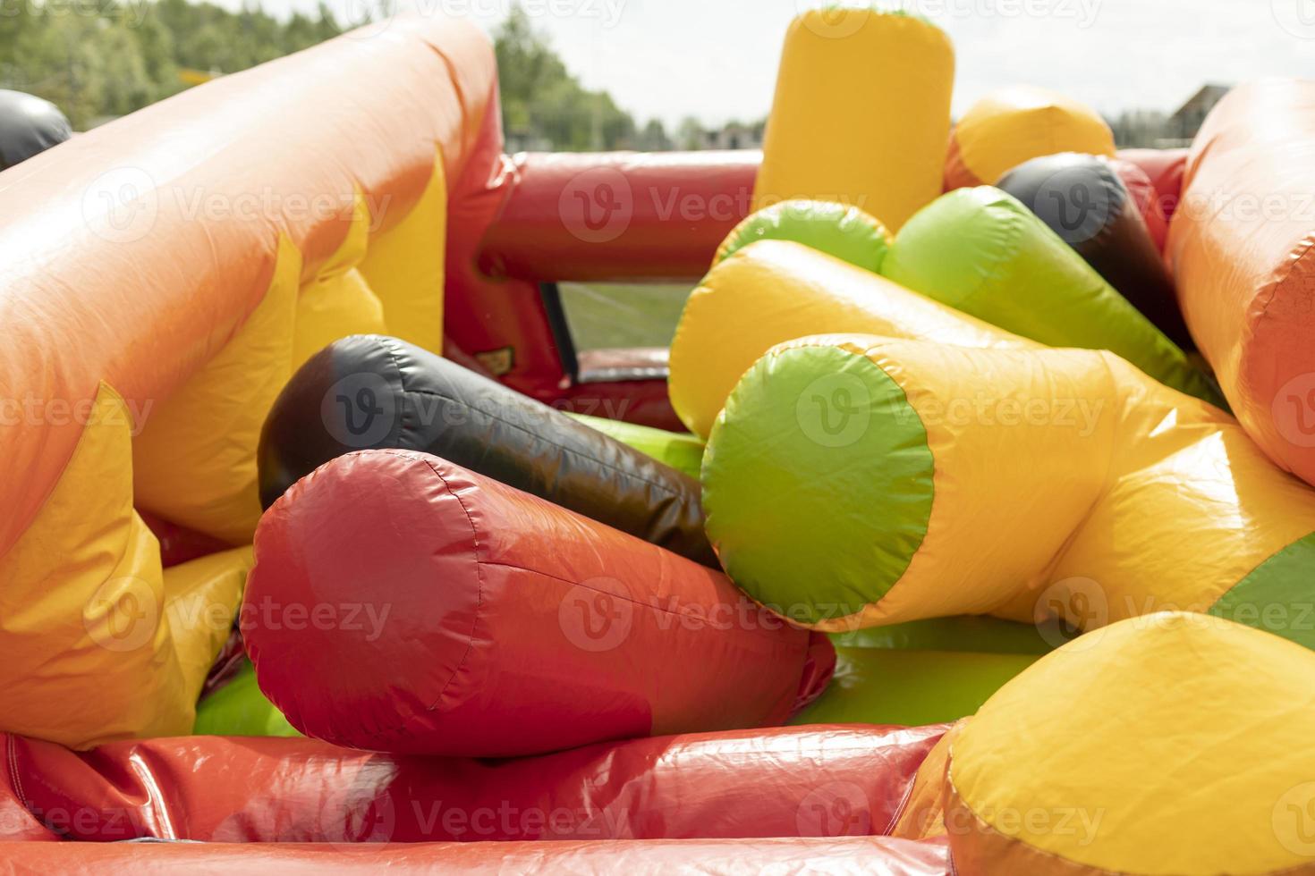 Deflating inflatable trampoline. Amusement park gathering. Details of playground. photo