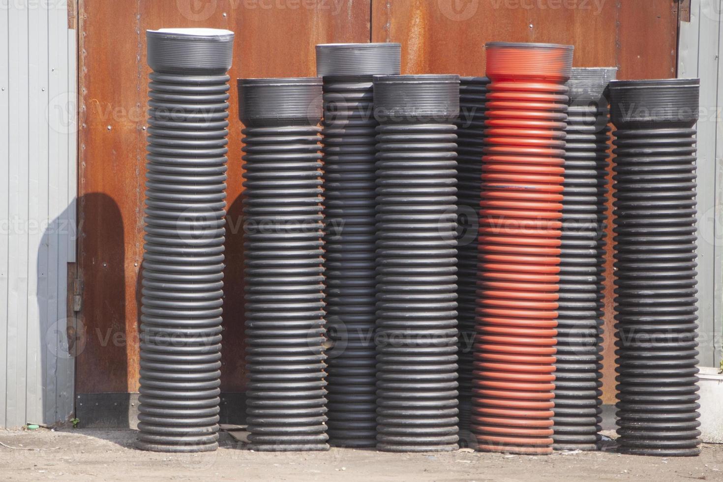 Plastic pipes for sewerage on street. Ribbed pipes in stock. Sewerage system. photo