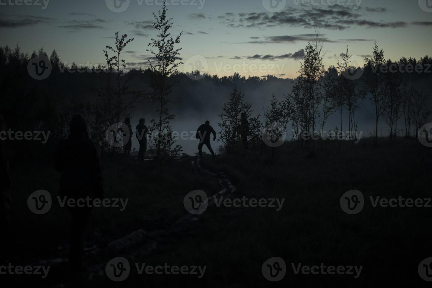 Man in fog before dawn. Rest on lake. photo