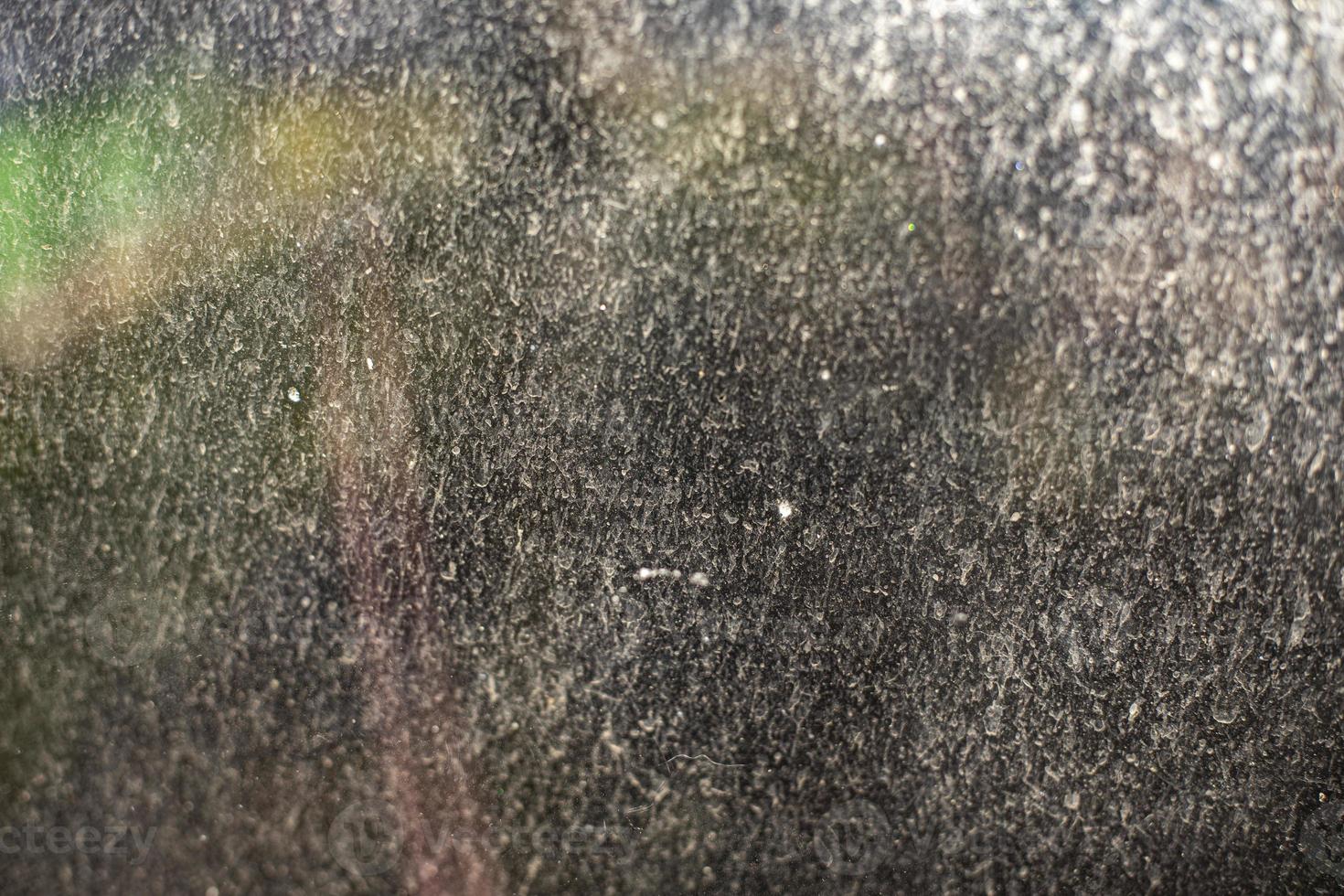 Plaque on glass in spring. Dirty window details. photo